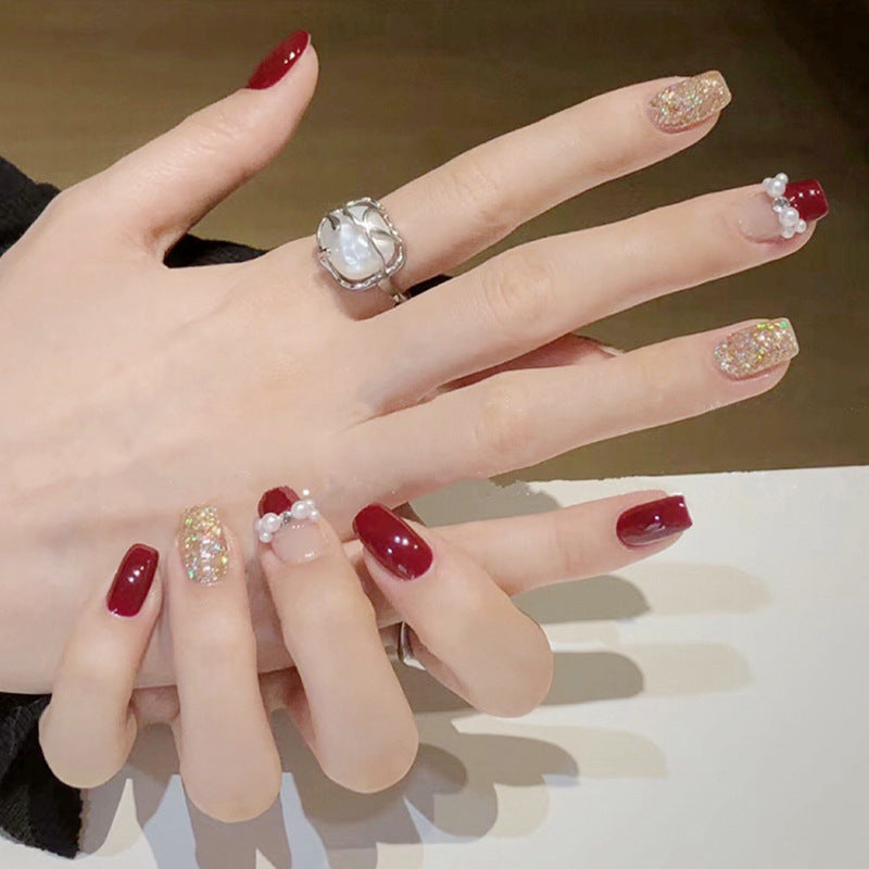 Glamorous artificial nails with glitter and pearl decorations Bowlift